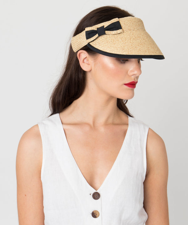 Natural straw visor with fabric trim and bow detail, elasticated band for adjustable fit, lightweight design for sun protection and summer wear.