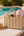 Oversized straw beach basket made from corn husk with textured weave, zip closure, interior pocket, fully lined, straw-wrapped handles, 54cm width, 52cm height.