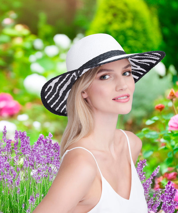 White wide brim straw hat with zebra print lining, contrast design, adjustable fit and UPF 50 sun protection for beach and summer wear.