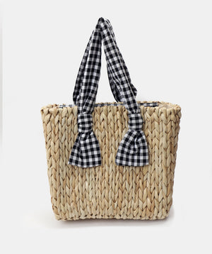 Straw woven tote bag with natural textured finish, gingham fabric handles, zip closure, 3 interior pockets, lightweight durable design for beach and summer use.