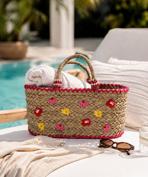 Straw beach basket bag with flower embellishment, top handles, lightweight seagrass design, large capacity, 44cm width, 37cm height, ideal for beach, shopping and summer use.