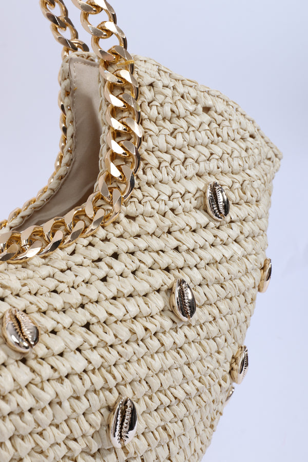 Close Up View: Sand Straw Bag with Gold Chain Handles and Shell Embellishment