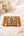 Woven rattan clutch bag with silver PU detailing, turn lock closure, detachable adjustable strap, 20cm width, compact lightweight design for day-to-night use.