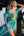 Woman in a colorful dress standing on a wooden pier.