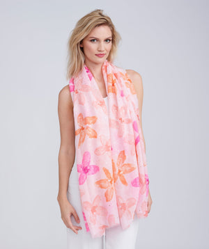 Light pink oblong summer scarf featuring a floral print with subtle lurex metallic detailing and delicate frayed hems. Made from soft, lightweight fabric with a smooth hand feel.