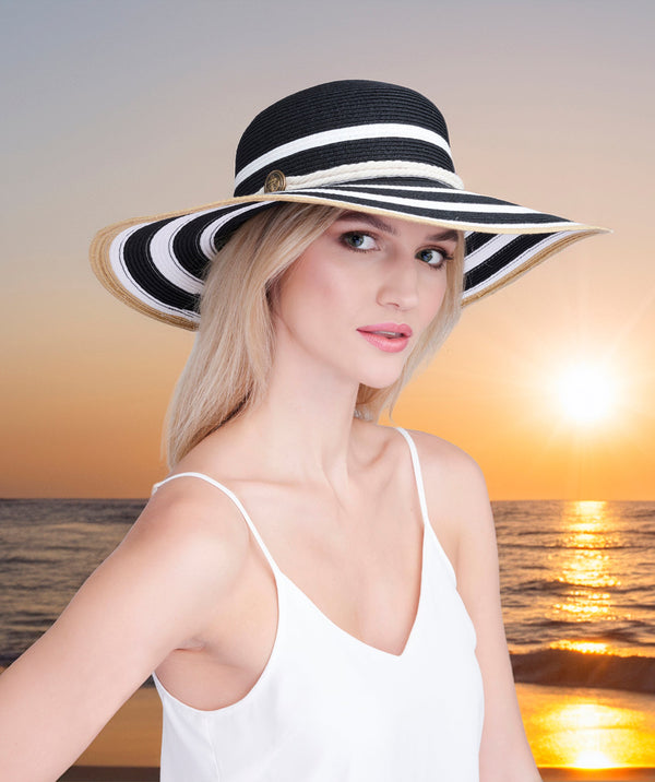 Black and white striped straw wide brim hat with adjustable fit, crushable design and UPF 50 sun protection for beach, holiday and summer outdoor wear.